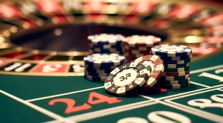 high-value chips stacked near the roulette layout